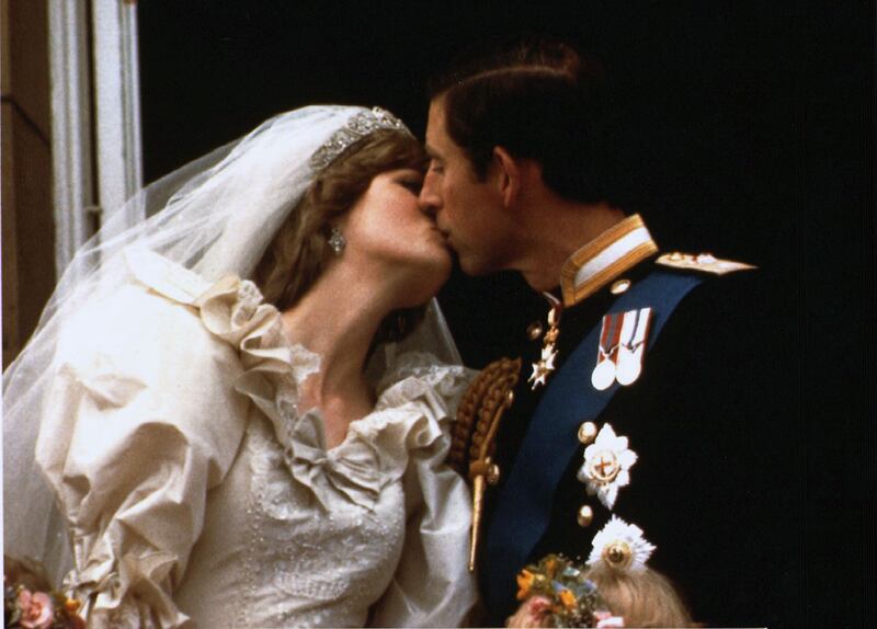 Prince Charles kisses Princess Diana on the Buckingham Palace balcony on their wedding day, July 29, 1981.