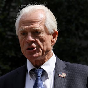 Peter Navarro, wearing a suit, speaks to reporters after a pre-trial conference in Washington.