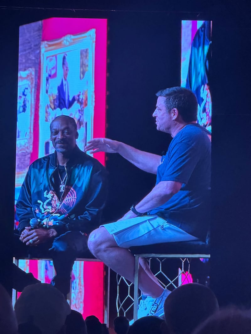 Snoop Dogg and Todd Graves sit on stage for Q&A.