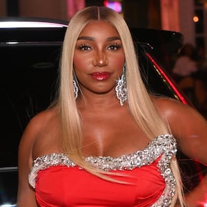 NeNe Leakes poses in a red dress at a birthday party in Georgia