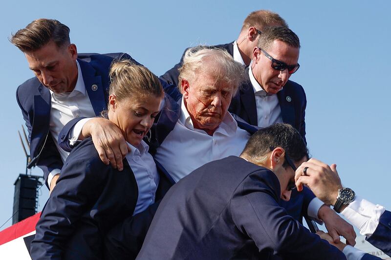 Republican presidential candidate former President Donald Trump is rushed offstage.