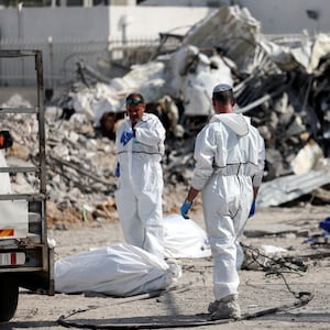 Israeli rescue workers remove dead bodies after a Hamas surprise attack on Oct. 7.