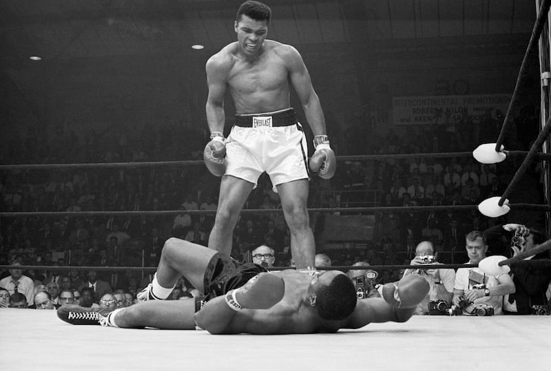 Heavyweight champion Muhammad Ali stands over Sonny Liston