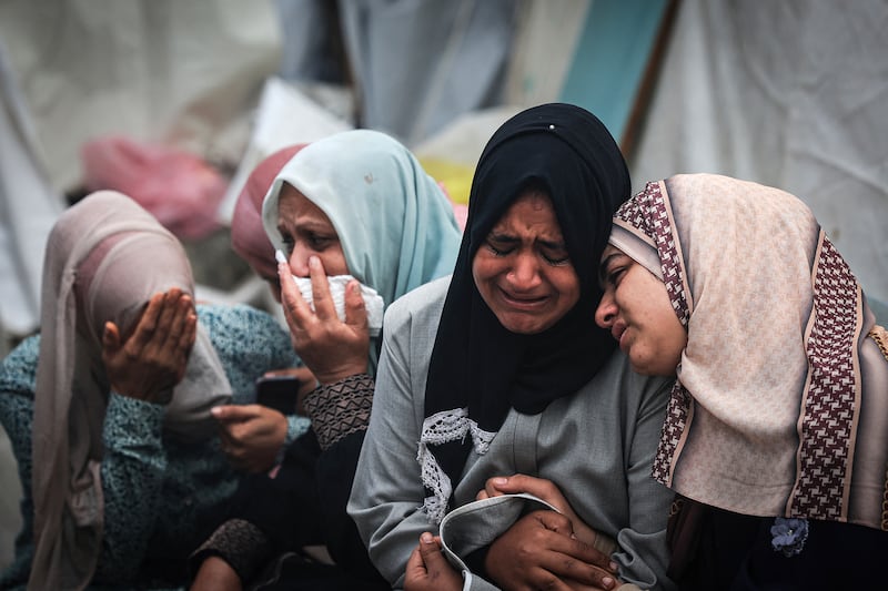 Palestinians mourn their relatives, killed in an overnight Israeli strike.