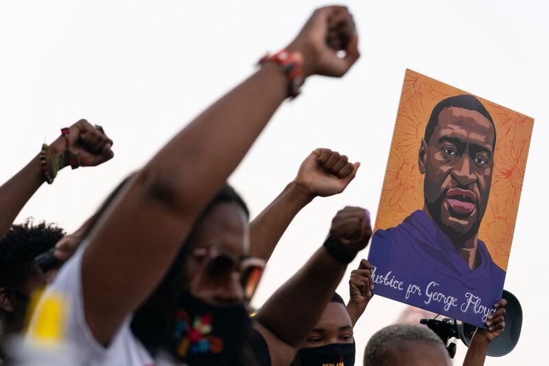 People raise their fists following the guilty verdict in the trial of Derek Chauvin on April 20, 2021, in Atlanta, Georgia