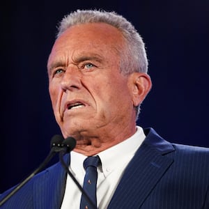 Robert F. Kennedy Jr. speaks in Phoenix behind a podium.