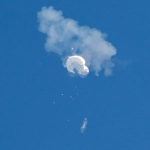 The suspected Chinese spy balloon drifts to the ocean after being shot down off the coast in Surfside Beach, South Carolina.