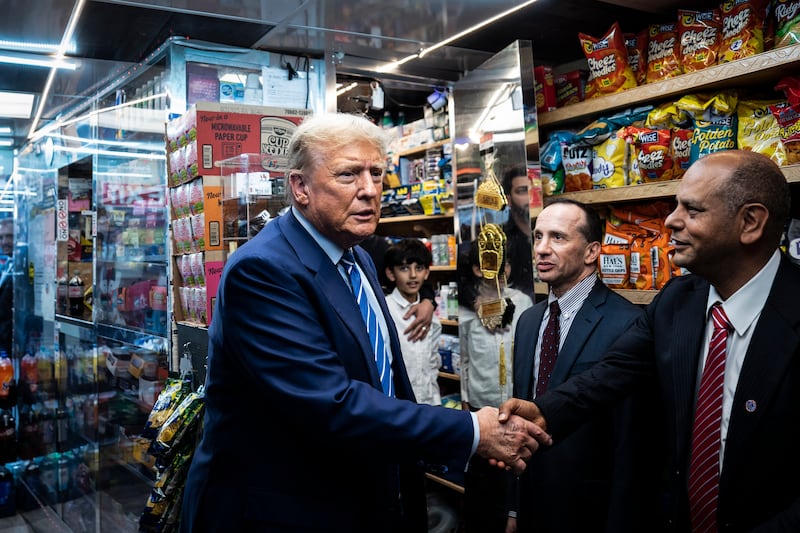 Trump shakes hands with Francisco Marte at Sanaa Convenient.