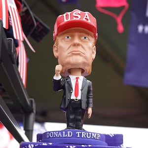 Vendors offer merchandise for sale at a rally with Donald Trump