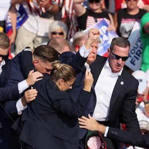 Republican presidential candidate and former U.S. President Donald Trump gestures with a bloodied ear as multiple shots rang out during a campaign rally at the Butler Farm Show in Butler, Pennsylvania, U.S., July 13, 2024. 