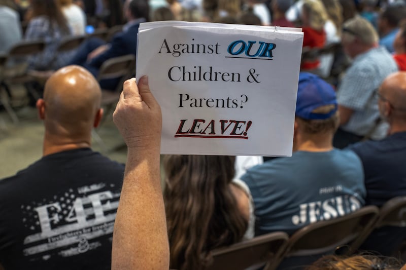 A person holds a sign in support of Chino Valley school board’s policy to require schools to ‘out’ students to parents if they ask to be identified by a gender not listed on their birth certificate. 