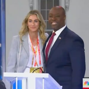 Tim Scott smiles with a mystery woman after Wednesday’s third GOP debate.