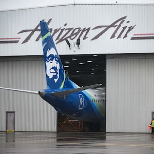 Alaska Airlines N704AL is seen grounded in a hangar at Portland International Airport. 