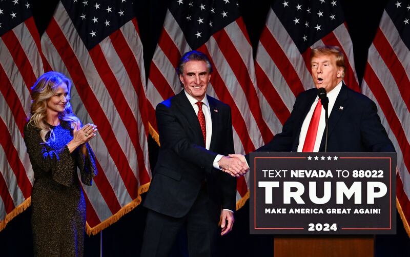 Kathryn Burgum and her husband Republican Governor of North Dakota Doug Burgum with former US President Donald Trump