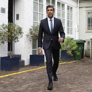 RIshi Sunak on brick patio outside his home in London