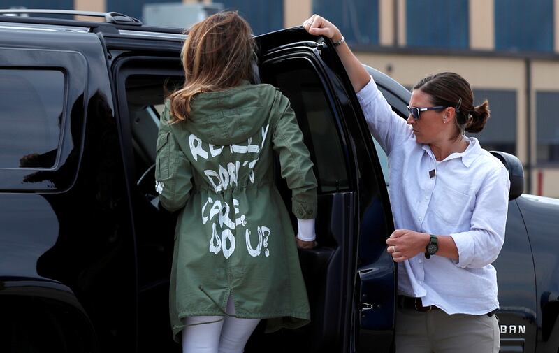 U.S. first lady Melania Trump climbs into her motorcade vehicle wearing a Zara design jacket with the phrase \"I Really Don't Care. Do U?\" on the back