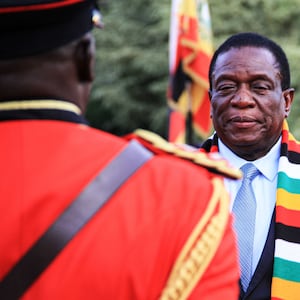 Zimbabwe's president Emmerson Mnangagwa (2nd L) reviews a guard of honour at the state house during his official visit to attend Uganda's 57th independence day in Entebbe, Uganda, on October 8, 2019