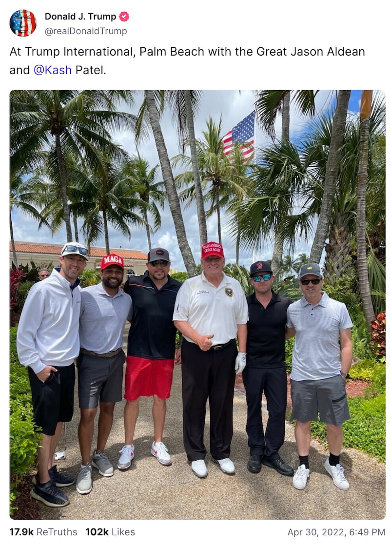 Donald Trump poses at Trump International Golf Course in Palm Beach with Kash Patel and others.