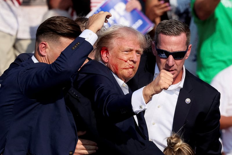 Trump bloodied and escorted by Secret Service