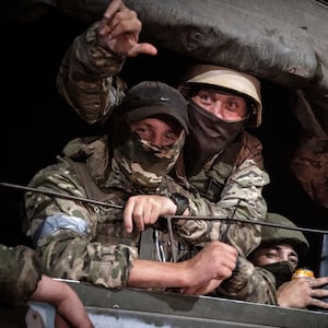 Members of Wagner Group look from a military vehicle in Rostov-on-Don late on June 24, 2023. 