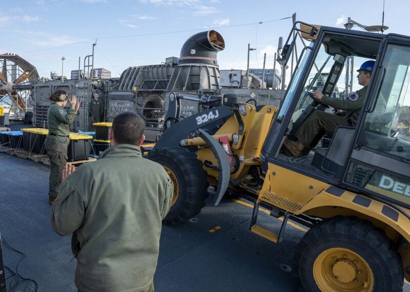 U.S. Navy personnel on Friday securing and transporting the remnants of a Chinese spy balloon