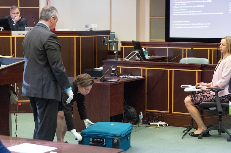 Sarah Boone demonstrates how Jorge Torres was trapped in the suitcase.