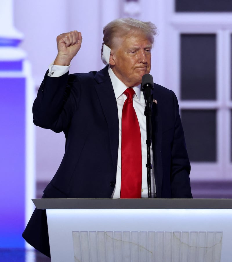 Donald Trump fist pumping at the RNC wearing an ear bandage