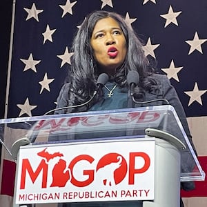 Kristina Karamo gives a speech at a podium for the Michigan GOP