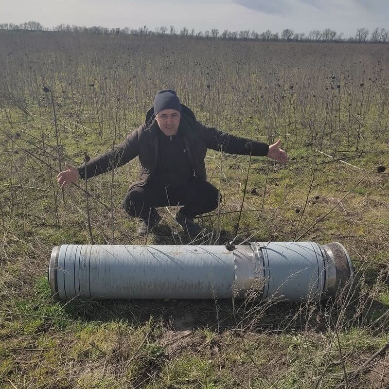 Sergey Teterdinko, in front of shrapnel found on a local farm in Ukraine, during the Russian Ukrainian war.