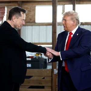 Elon Musk shakes hands with Republican presidential nominee, former President Donald Trump back stage during a campaign rally at the Butler Farm Show grounds on October 05, 2024 in Butler, Pennsylvania.