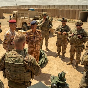 U.S. Army Soldiers assigned to Bravo Battery, 1st Battalion, 134th Field Artillery Regiment, 37th Infantry Brigade Combat Team, and Iraqi Army officer.