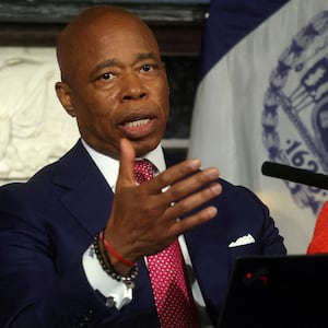 Eric Adams, wearing a suit and tie, speaks during a press conference.