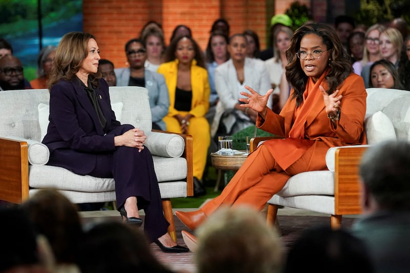 Kamala Harris sits opposite Oprah Winfrey at a campaign event.