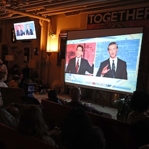 People watch a debate between California Gov. Gavin Newsom and Florida Gov. Ron DeSantis