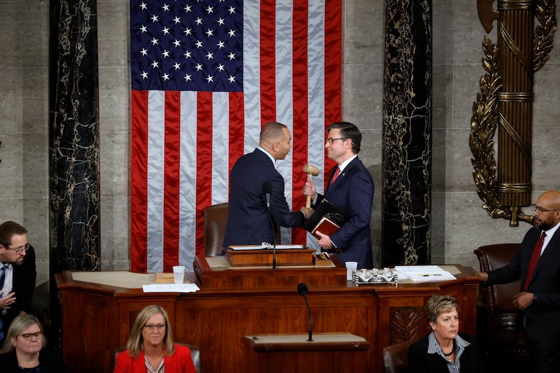 Photograph of Hakeem Jeffries handing the Speaker gavel to Mike Johnson.