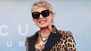 Sharon Stone smiles in sunglasses.