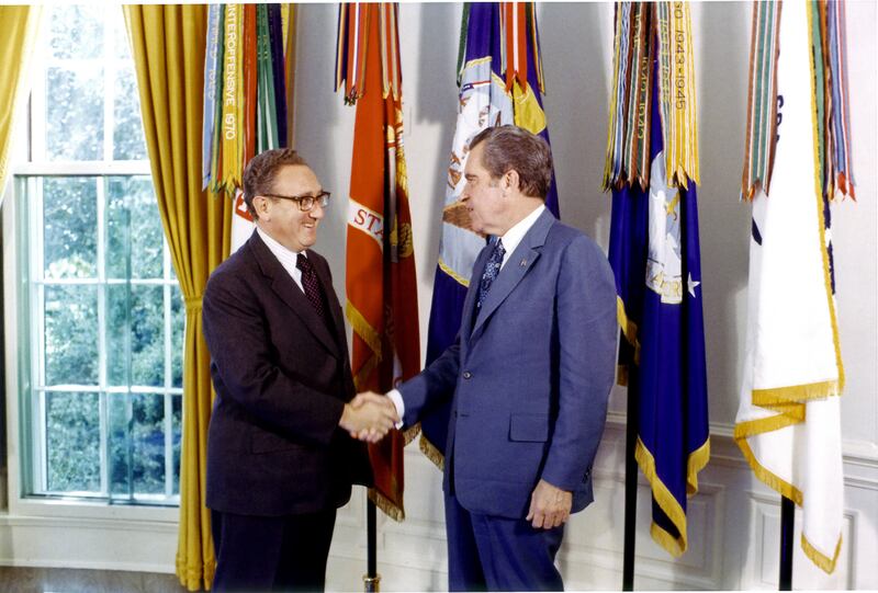 A photo including a portrait of former US Secretary of State & National Security Advisor Henry Kissinger and Former U.S. Richard Nixon