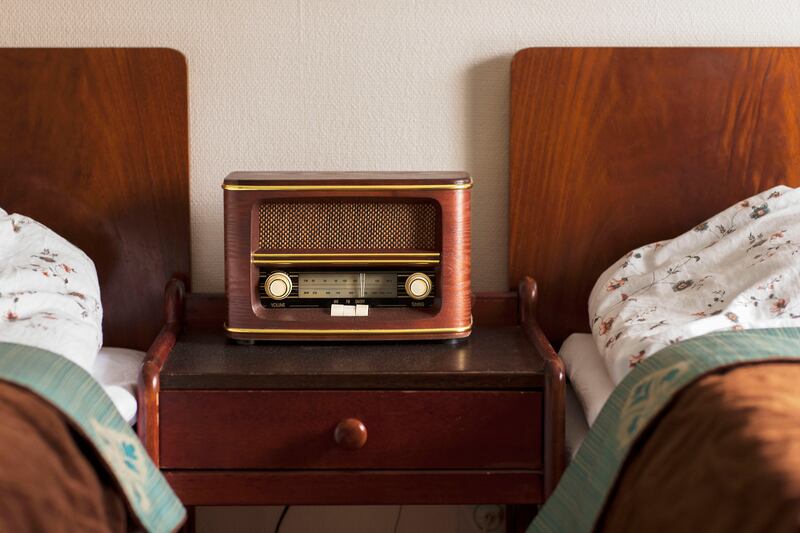 Two vintage twin beds with a radio between them