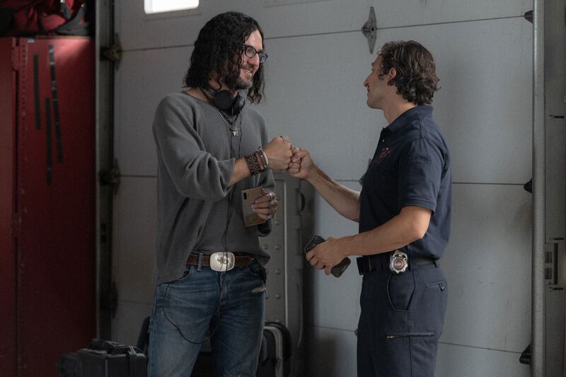 Benny Safdie as Dougie and Zachary Enriquez as Handsome Firefighter