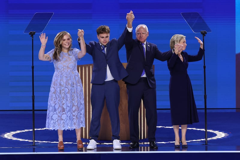 U.S. Democratic vice presidential nominee Minnesota Governor Tim Walz stands onstage with his wife Gwen, his son Gus and his daughter Hope