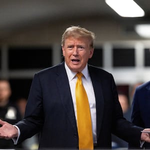 Former U.S. President Donald Trump talks to the press while standing with his attorney Todd Blanche at the end of the day at his criminal trial at New York State Supreme Court on May 21.