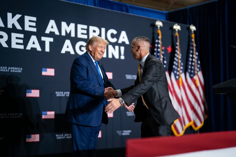 Former President Donald Trump speaks with Corey Lewandowski at a campaign rally in 2023.