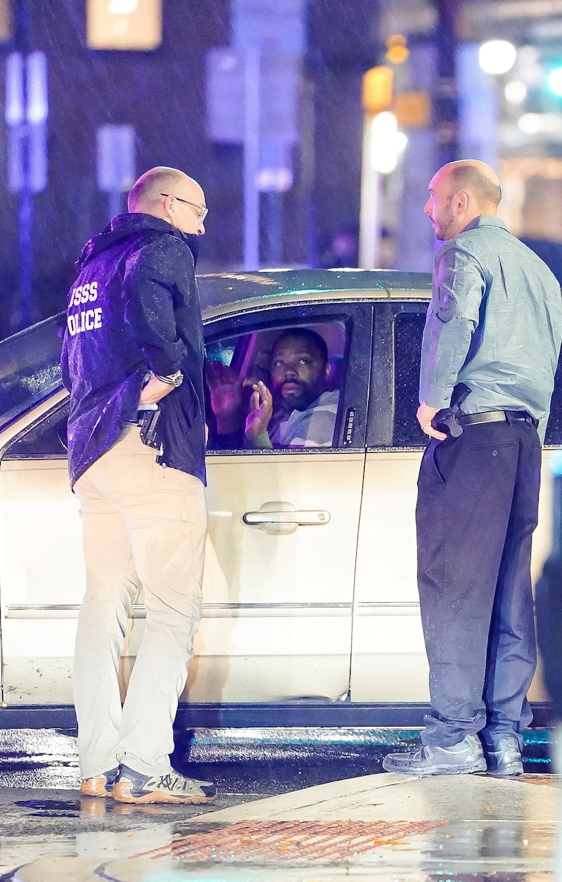 Members of the United States Secret Service speak to the driver of the vehicle that crashed into a Secret Service SUV.