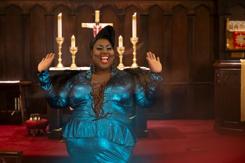 Latrice Royale stands inside of a church in a still from ‘We’re Here'