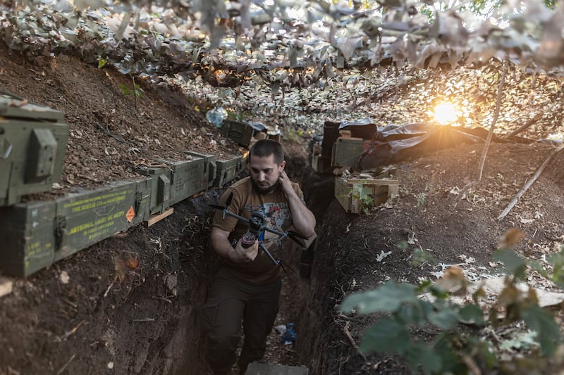 Ukrainian soldier carries a drone in a trench in the direction of Bakhmut as the Russia-Ukraine war continues in the Donetsk Oblast, Ukraine on August 10, 2024. 