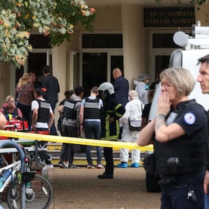 French police officers from the forensic service stand in front of the Gambetta high school in Arras, northeastern France on October 13, 2023.