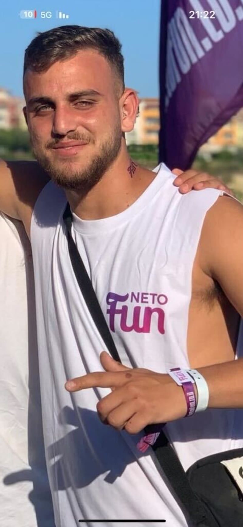 A picture of a happy Itay Glisko in a white sleeveless t-shirt