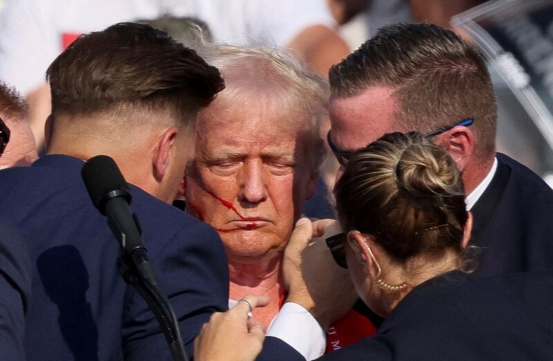 Trump bloodied surrounded by Secret Service agents