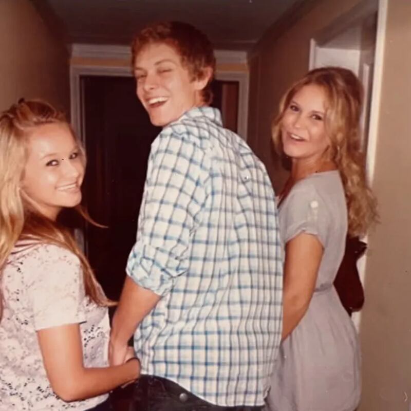 Mac Sinise smiles and holds hands with his sisters.