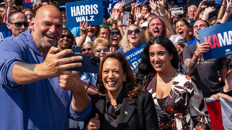 Kamala Harris, center, takes a selfie with Sen. John Fetterman (D-PA), left, and his wife Gisele Barreto Fetterman, right, after greeting supporters at John Murtha Johnstown-Cambria Airport on September 13, 2024 in Johnstown, Pennsylvania.